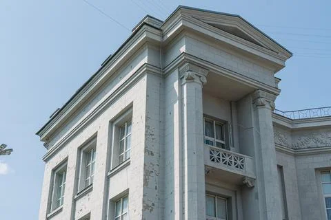 Light-colored, classical urban building with columns, pediment, ornamentation Stock Photos