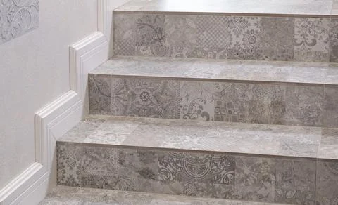 Light colored patterned tile steps in house. Decorative putty. Furniture in Stock Photos