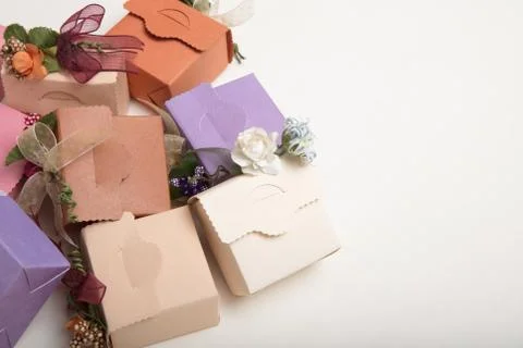 Light colours gift boxes  with flowes and ribbons, on white background Stock Photos