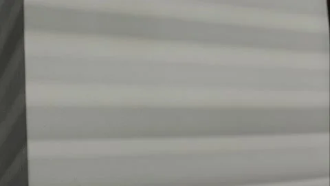 Light comes through the blinds, the blinds open, the light gets brighter. Stock Footage 233179324