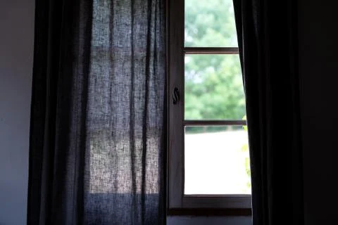 Light coming though partly open gray curtains Stock Photos