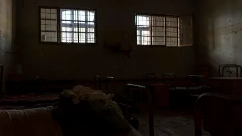 Light Coming in Through Prison Cell Bars Window. Jail Cells. Prison Interior. 库存照片