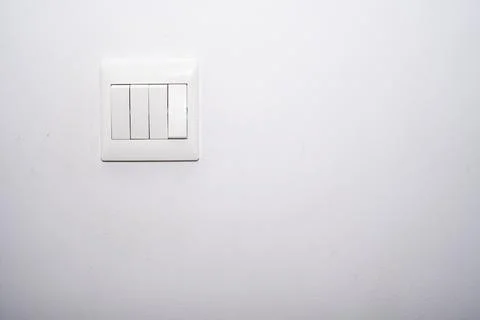 Light control switch white color installed on the white color wall in a room Stock Photos