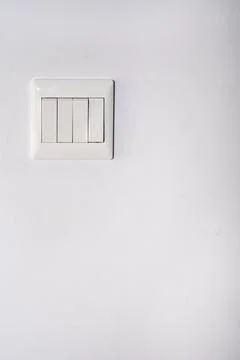 Light control switch white color installed on the white color wall in a room Stock Photos
