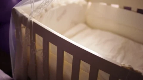 Light cradle for a newborn with a big teddy bear Video stock 70754744