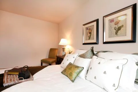 Light cream bedroom with refreshing bedding Stock Photos