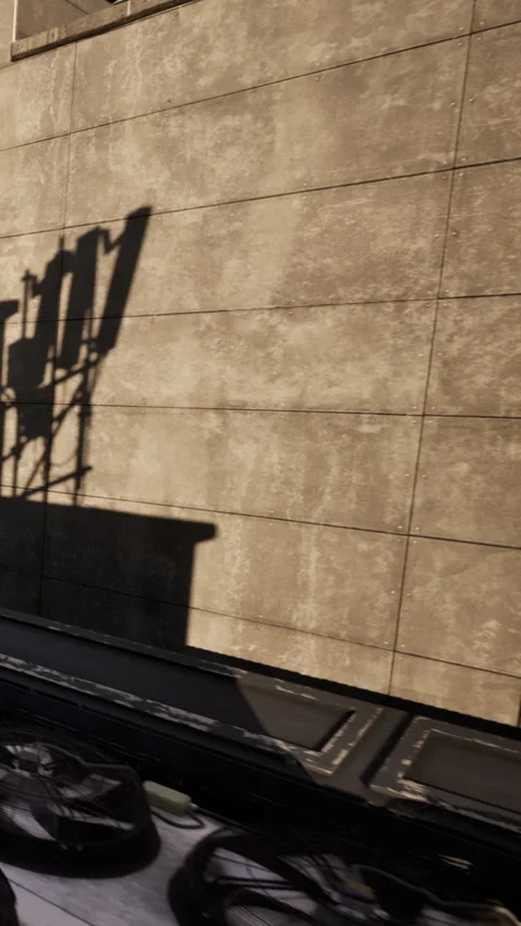 Light creates shadow patterns on wall during afternoon time in urban setting Stock Footage 340636935
