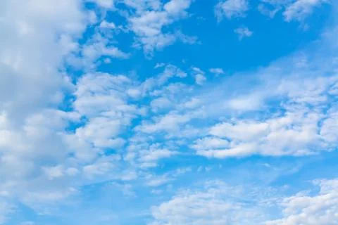 Light cumulus clouds in the blue sky on a sunny day, full frame image, backgr Stock Photos