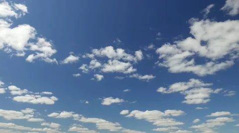 Light cumulus clouds quickly whirl on deep blue sky, time lapse shot Stock Footage 65783524
