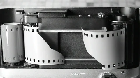 Light-damaged and torn film in the camera Stock Footage 122625718