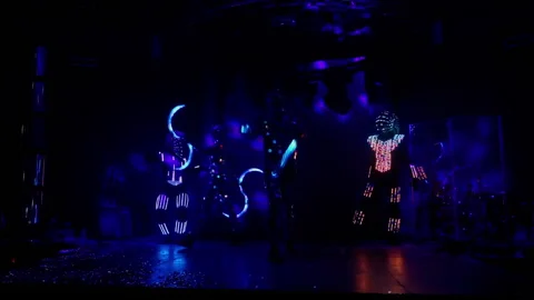 Light dance show performance on stage in club. Glowing clothes on dancers Stock Footage 164214783