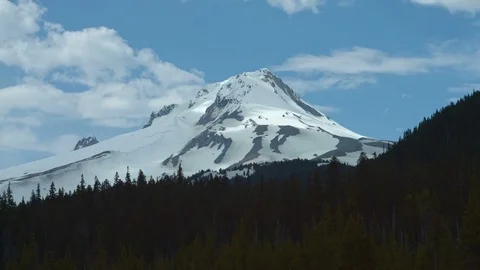 Light dances on snowy mountain peak timelapse Mt. Hood Spring Forest Oregon Stock Footage 81762461
