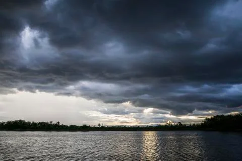 Light in the Dark and Dramatic Storm Clouds background Stock Photos