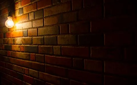 Light in the dark, old lamp on the wall, old brick wall with light 스톡 사진