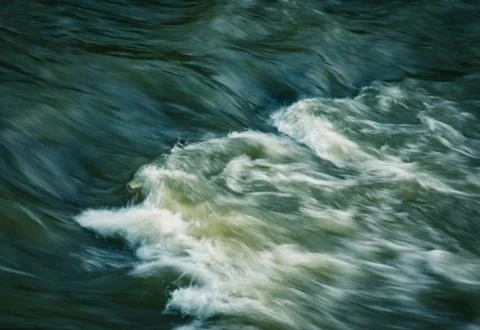 Light on the dark river rapids Stock Photos