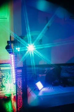 Light display setup in room for event during nighttime with colorful beams an Stock Photos
