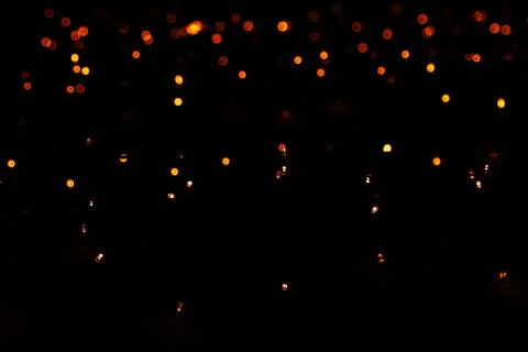 Light dots black background. blurred abstract pattern, bokeh background. Stock Photos