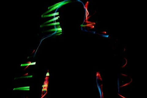Light effect Multicolored blurred lines on a black background. Dark male Stock Photos