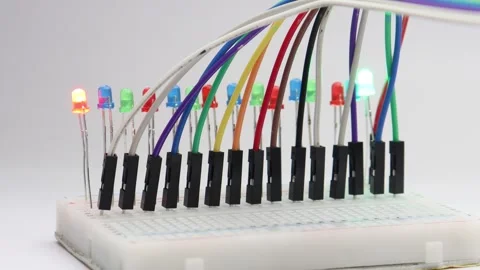 Light emitting diodes of various color glowing in sequence on a breadboard Stock Footage 339017959