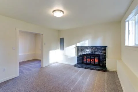 Light empty living room interior with milky walls framing a wall mounted fire Stock Photos