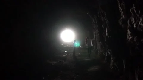 Light at the end of a long cave and children. 動画素材 148460964