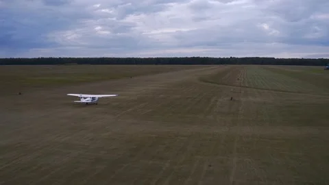 A light-engine airplane takes off in a field. Stock Footage 279915367