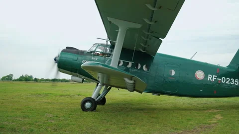 Light-engine Green Airplane move across the Field. Gaining Speed for Takeoff Stock Footage 196202889