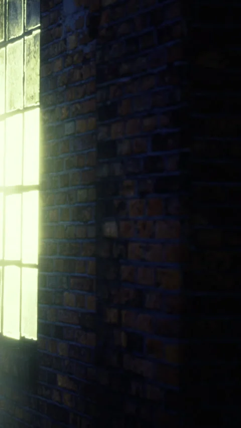 Light entering a building through a window in a brick wall during evening hours Stock Footage 335962594