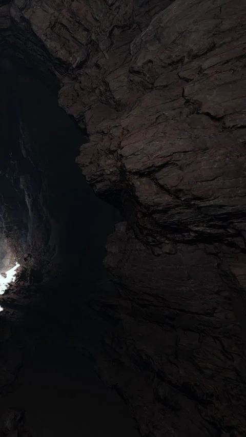 Light entering a cave during the day creates contrast with shadows on the walls Stock Footage 341270795