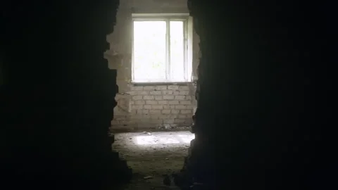 Light Entering Through Hole in Dark Room Wall Illuminating White Brick Wall and Stock Footage 304943804