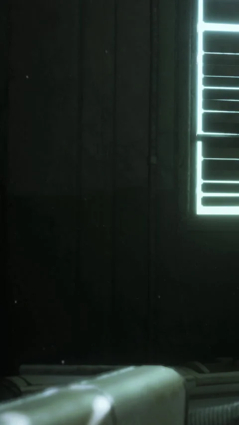 Light enters through a window with shutters in a dark room during evening Stock Footage 337970383