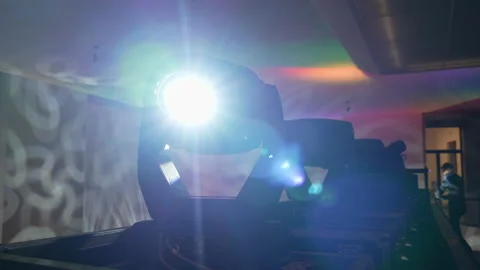 Light equipment with searchlight work on frame above stage Stock Footage 237462212