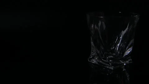Light Fading on Empty Modern Whiskey Glass Stock Footage 140817066