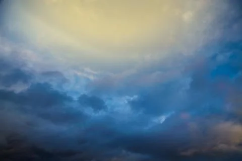 Light falls on the clouds from above, light breaks through and illuminates th Stock Photos