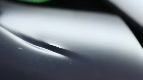 Light falls on unevenness highlighting slight damage to metal Stock Footage 316175155