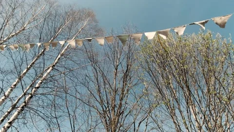 Light festive small flags of a triangular shape swaying in the wind. Clip Stock Footage 147765351