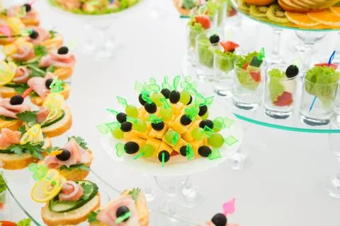 Light festive snacks on the white table Stock Photos