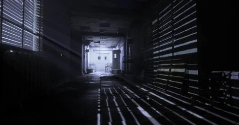 Light filtering through blinds in an abandoned building at night Ilustración de archivo