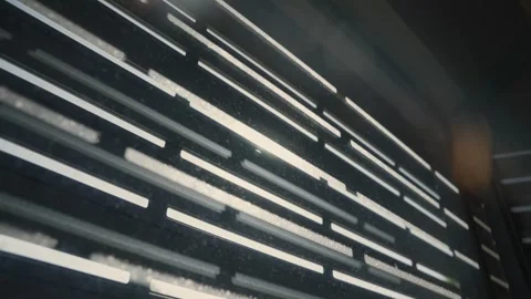 Light filtering through modern building facade louvers Vídeos de archivo 316069044