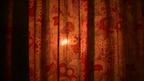 Light from the fire behind the old curtain Stock Footage 138390585