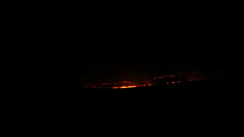 Light from a fire in the distance Stock Footage 170745196