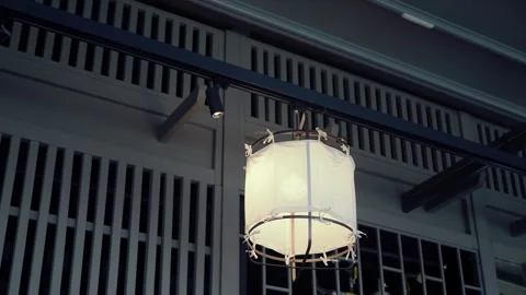 Light fixture hangs above the dining area in a restaurant Vídeo Stock 328692061