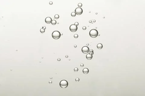Light fizz bubbles soars over a blurred background Stock Photos