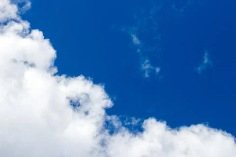 Light fluffy clouds against a blue sky Stock Photos