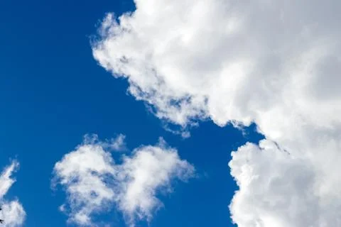 Light fluffy clouds against a blue sky Stock Photos