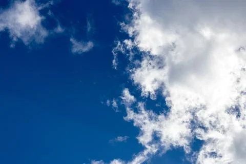 Light fluffy clouds against a blue sky Stock Photos