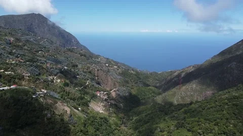 Light fluffy clouds drift over small mountain village of Galipán, Stock Footage 130299253