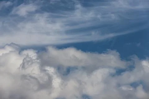 Light fluffy white clouds on a blue sky Stock Photos