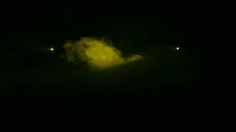 Light is generated yellow profile spotlights in the dark in a smoke blanket. Stockbeeldmateriaal 122638192