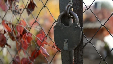 The light goes through the old key lock of a gate Stock Footage 126657896